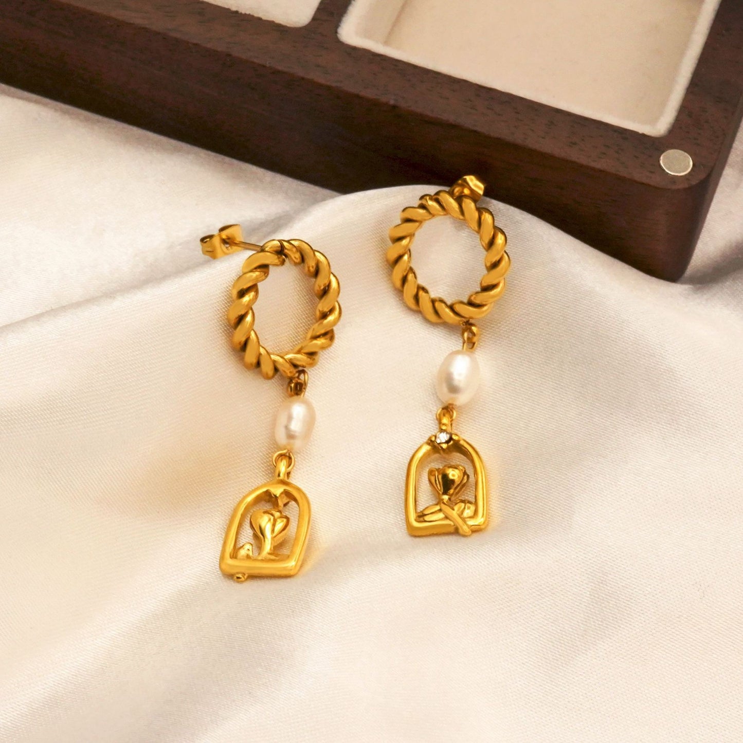 Nicholas painting pearl earrings